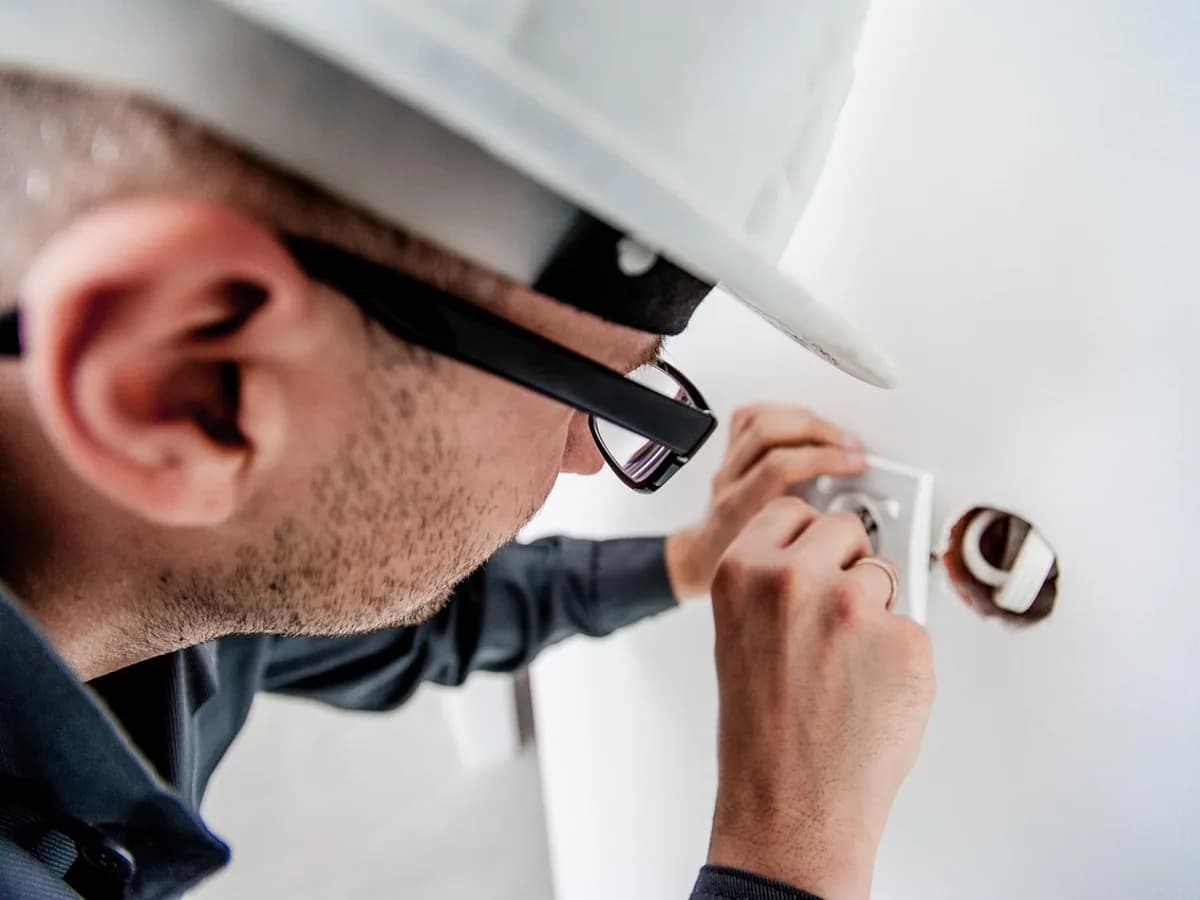 Electrician fitting an electrical socket in a home