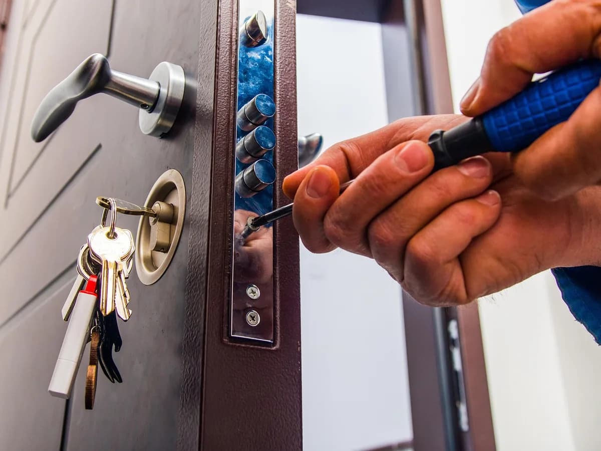 Locksmith adjusting a lock on a residential door
